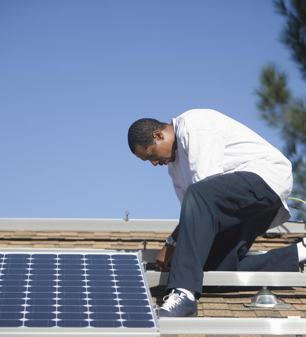 man on the roof installing solar panels